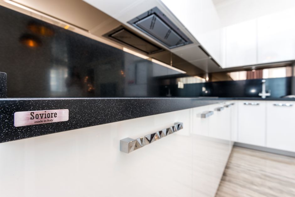 Modern kitchen with white cabinets and a countertop.